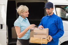 delivery-driver-showing-where-to-sign-to-customer-outside-warehouse-49902000